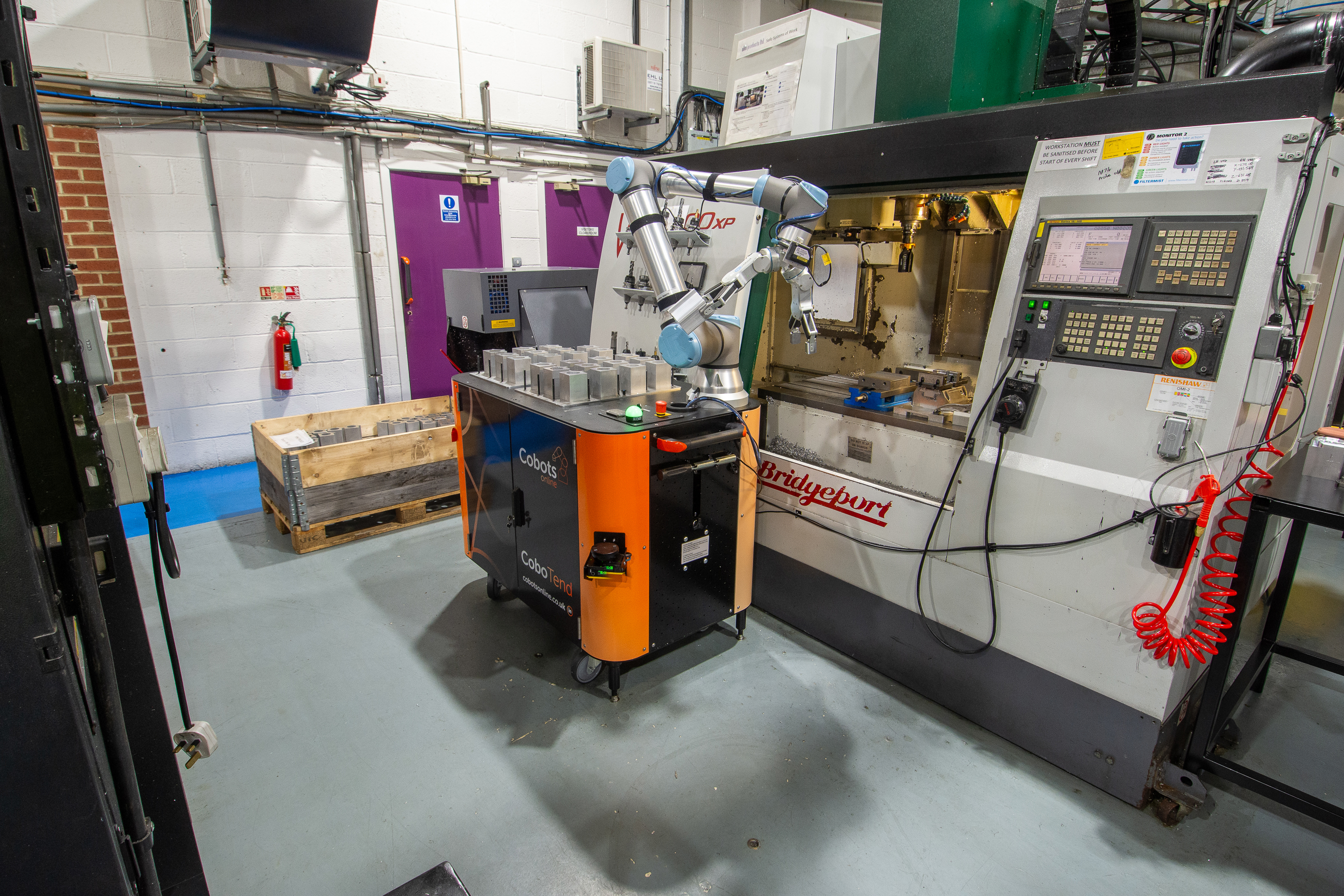 CoboTend, the collaborative robot from Cobots Online, working on a milling machine in a factory