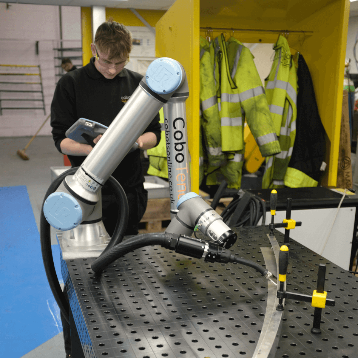 Welding cobots - worker using welding cobot at work station