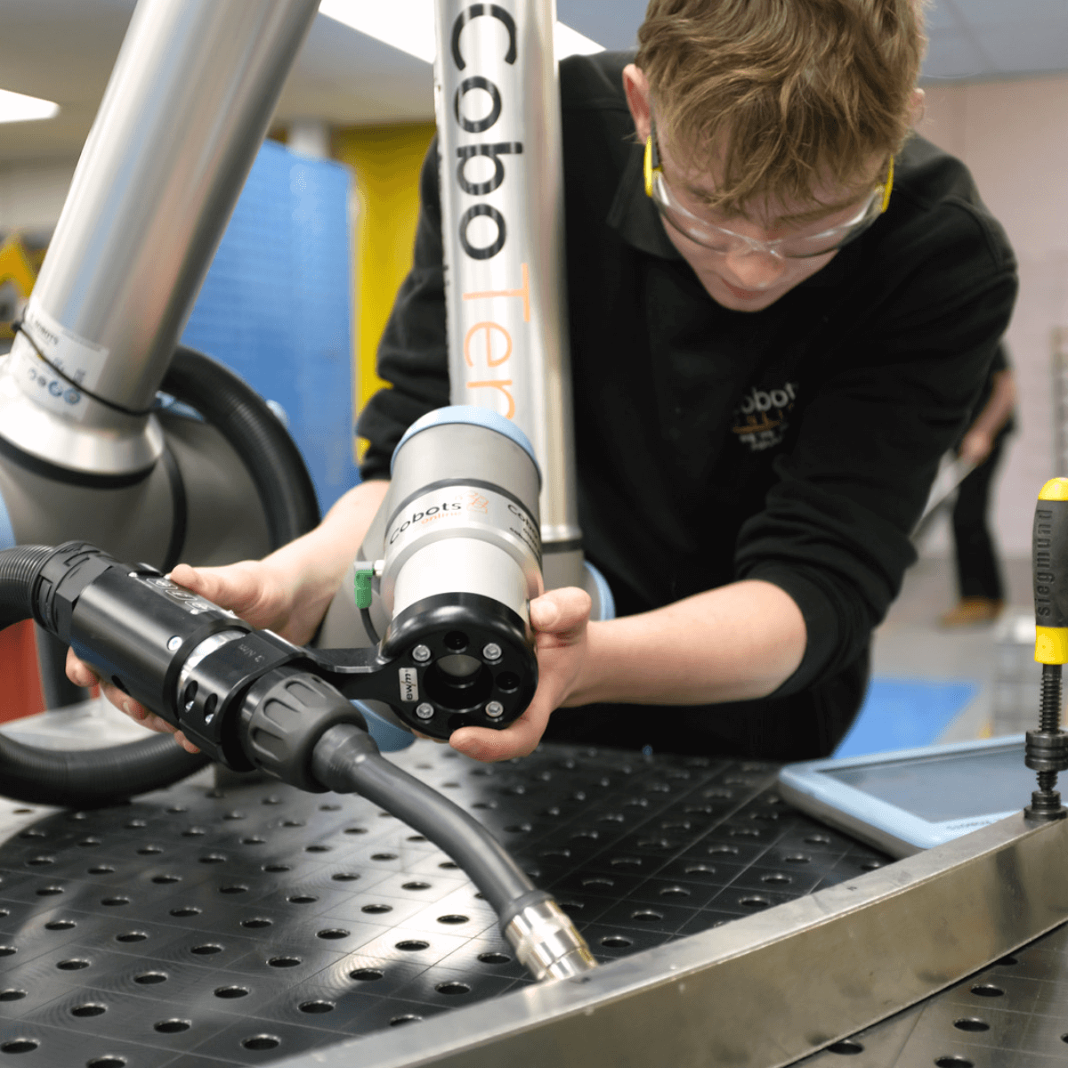 Working using hand guidance to program welding cobot 