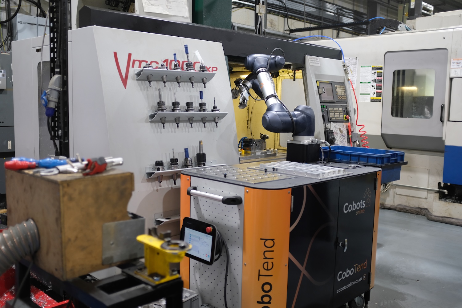 collaborative robot working on machine in factory